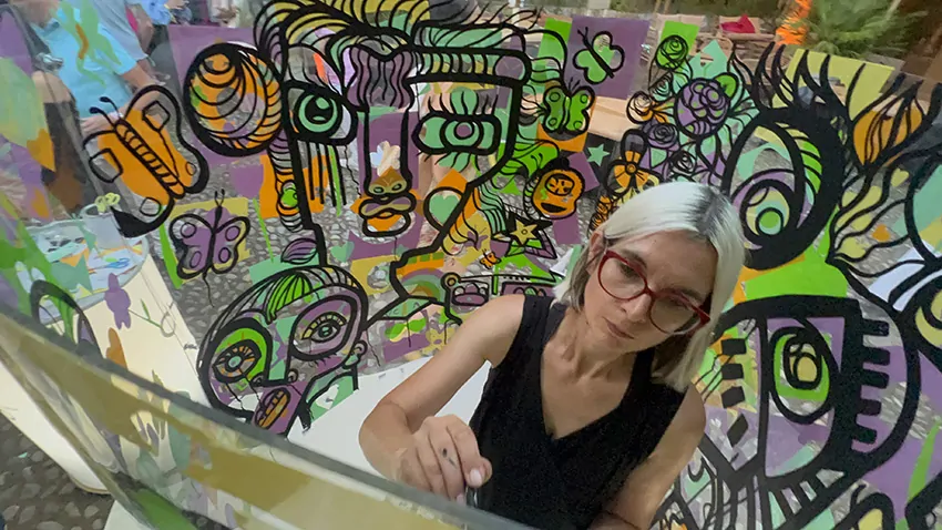 ana artiste dans son tube plexi lors de l'animation originale fresque en garden party à Genève organisée par My Art Box