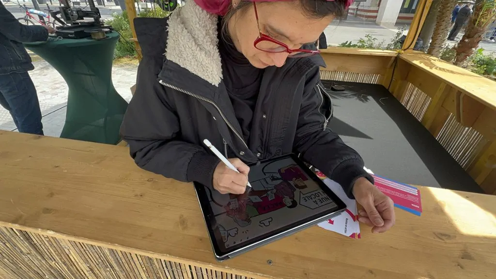 aNa est une artiste digitale qui travaille sur I Pad lors de son animation fresque facilitation graphique digitale à Abbeville et partout en France au même prix