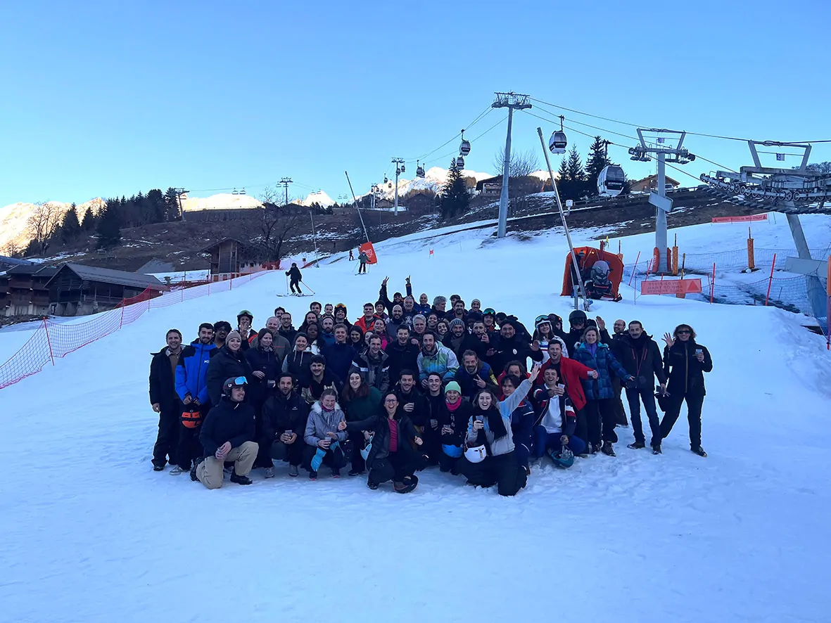 Le groupe des collaborateurs qui posent dans la neige à la montage lors d'un séminaire représente le jeu des valeurs relationnelles de Terre et Lac