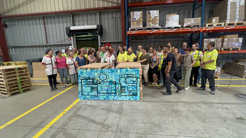 Le groupe des participants au team building artistique à Saint Etienne animé par Christophe Chazot pose devant leur tableau souvenir maintenant exposé dans l'atelier